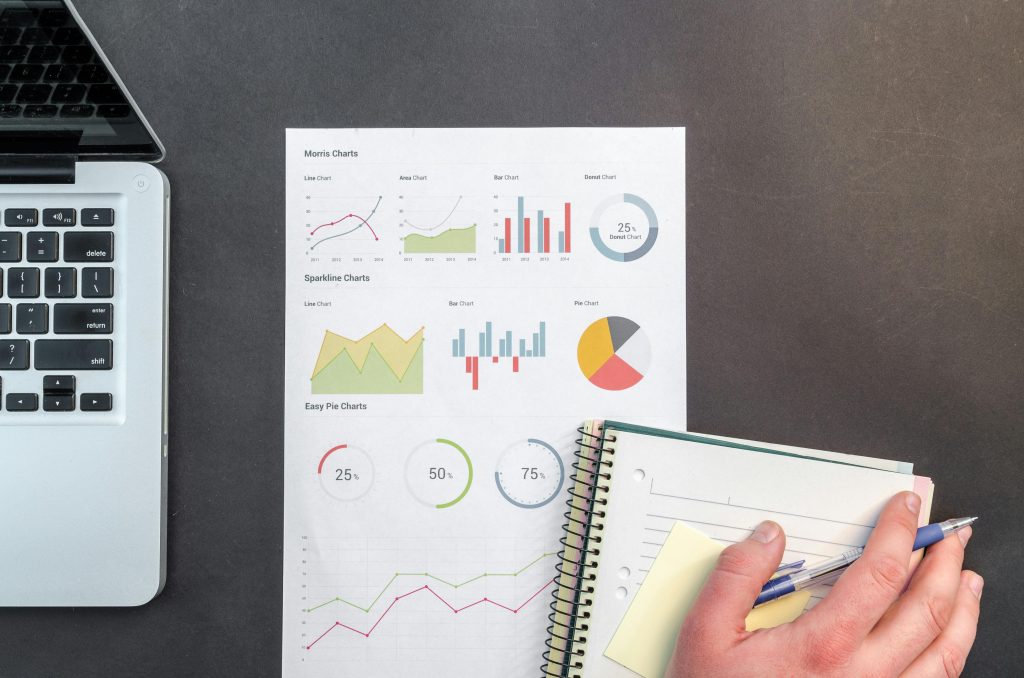 pexels-photo-669610-669610 Overhead view of a business desk with charts and a laptop, ideal for data analysis concepts.